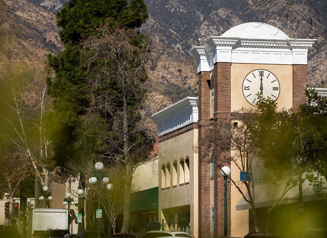 Monrovia, CA - View of a Commercial Building with a Clock Tower in Downtown Monrovia California with Mountains in the Background